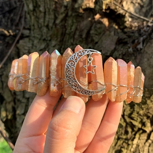 Detail of bohemian crystal crown with orange quartz stones and silver moon star charm