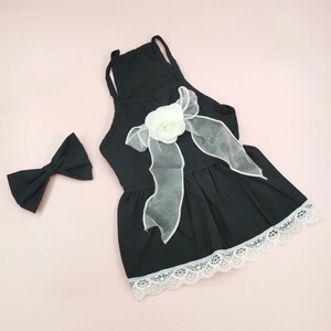 Detailed view of a black floral pet dress with lace edges and a matching bow tie
