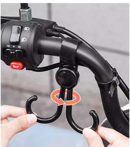 Close-up of double rotating hooks with velcro strap on a motorcycle handlebar