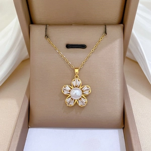 Detailed view of luxury five-petal flower pearl necklace with zircon accents in a gift box