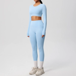 Detail of light blue yoga set featuring high waist leggings with side pockets and cropped top