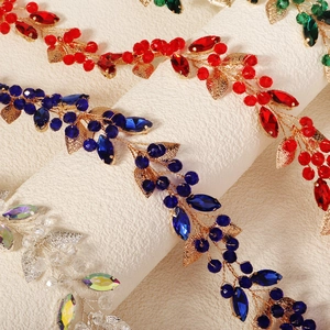 Detail of handmade bridal headbands with colorful crystals and metallic leaf weaving