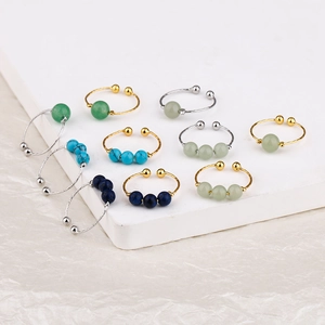 Set of 11 adjustable rings in gold and silver finish featuring colorful small beads