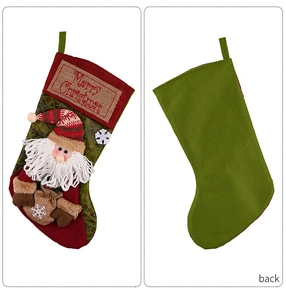 Detail showing the front and back of a red and green Christmas stocking with Santa applique