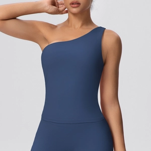 Detail view of navy blue one-shoulder yoga top with elastic matte fabric and slim fit