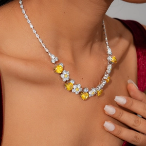 Close-up of luxury flower necklace with yellow heart-shaped zircon on a model