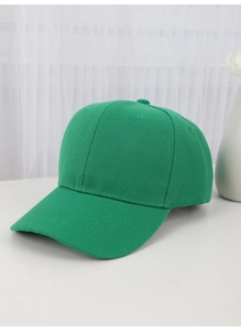 Close-up of a minimalist green cotton baseball cap against a clean lifestyle background