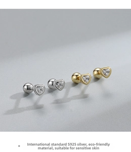 Detail of S925 sterling silver heart-shaped stud earrings in gold and silver finishes