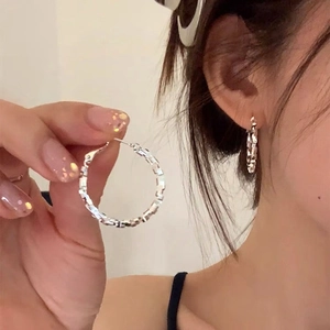 Minimalist silver textured hoop earrings shown on a model for casual daily wear