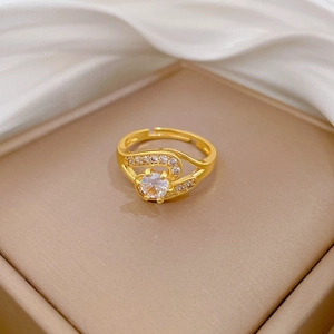 Detail of adjustable gold ring with brilliant round zircon and pavé diamond wavy band