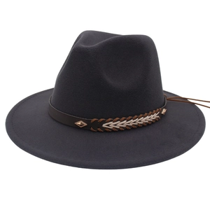 Detail of dark charcoal wool jazz hat featuring a brown leather woven band and metal stud