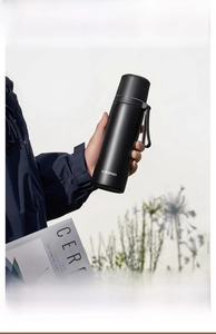 Detail of a matte black 316 stainless steel vacuum flask with a portable carry strap