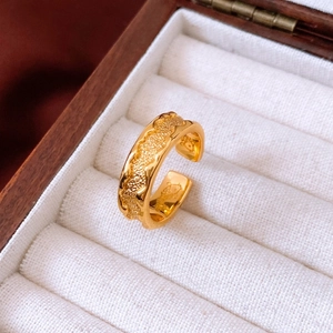 Macro view of gold vintage open ring with wavy edges and frosted texture in jewelry box
