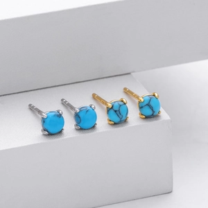 Close-up of S925 sterling silver stud earrings with round natural green turquoise stones
