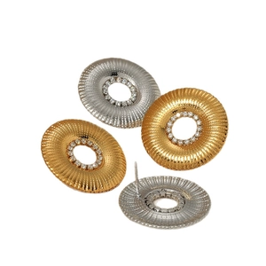 Gold and silver stainless steel sunburst earrings with sparkling center rhinestones