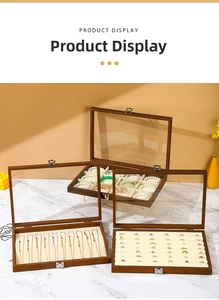 Walnut finish jewelry box detail featuring glass lid and soft beige velvet interior lining