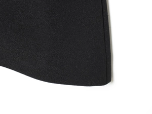 Detailed macro view of black woven fabric texture on a minimalist short sleeve top