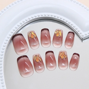 Handmade red cat eye press-on nails with silver lines and sparkling rhinestone accents