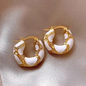 Elegant gold-plated lava enamel hoop earrings with white glaze on champagne silk cloth