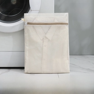 Detail view of a beige fine mesh laundry bag in medium size 40X50cm with zipper