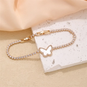 Elegant gold butterfly bracelet with white shell wings and sparkling zircon pavé