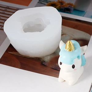 Macro detail of unicorn silicone mold with finished resin craft on creative background