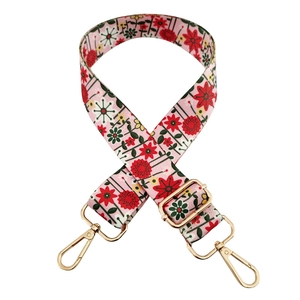 Detail of adjustable floral replacement bag strap with pink base and golden metal hardware