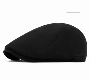 Detail of the black wool blend knit texture and side profile of the warm newsboy cap