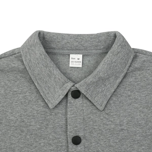 Close-up of gray jacket neckline showing Size M and 100% polyester care label