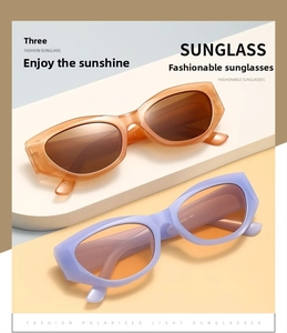Close-up of amber and lavender cat-eye sunglasses on a modern geometric display stand