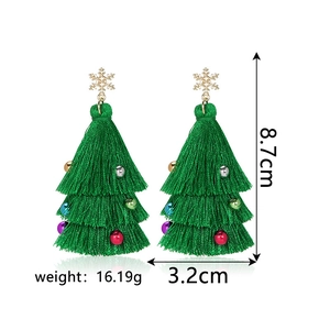 Detail of Christmas tree tassel earrings with golden snowflake and colorful beads