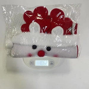 Detailed view of a plush cartoon Christmas gift bag weighed on a scale in clear packaging