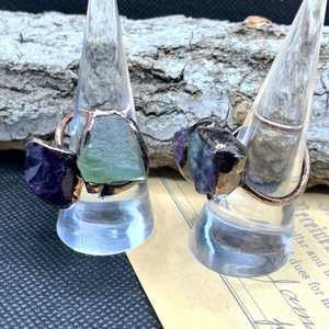 Close-up of vintage bronze adjustable ring with raw amethyst and green fluorite stones