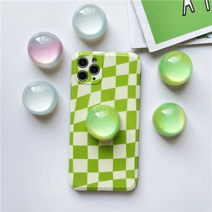 Detail view of aurora crystal phone grips on green and white checkerboard case
