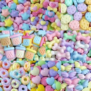 Assorted macaroon resin charms including donuts, stars, and hearts for DIY nail art and crafts