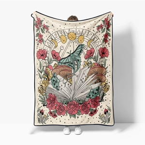 Detail of soft flannel throw blanket featuring vintage moth, moon phases and floral art