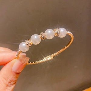 Detail of rose gold pearl bracelet with sparkling zircons and a luxurious French design