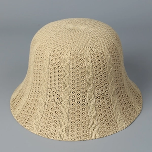 Detailed close-up of beige knitted bucket hat featuring hollow breathable mesh pattern