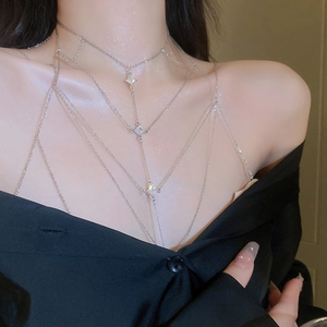 Macro view of multi-layer silver body chain with three sparkling zircon diamond pendants