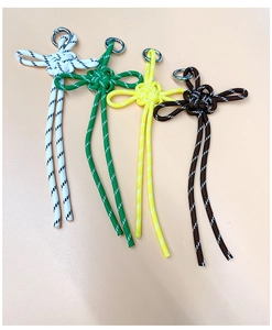 Detail of colorful paracord woven keychains in white green yellow and brown colors