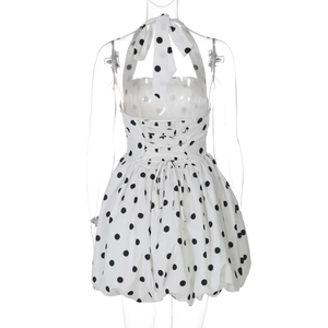 Detail view of the back tie-up backless design on a black and white polka dot dress