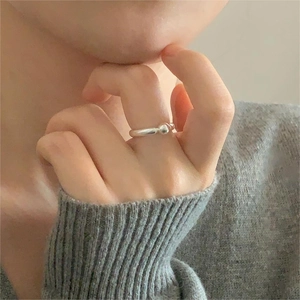 Detail of minimalist 925 sterling silver ball ring on model with silver sphere accent