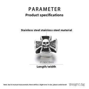 Macro shot of 14x13mm stainless steel skull cross spacer bead with vintage finish