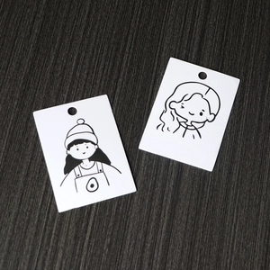Minimalist white jewelry display cards with cute cartoon girl illustrations on wood background