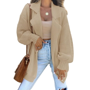 Detailed close-up of khaki knit cardigan showing lapel collar and chunky ribbed texture