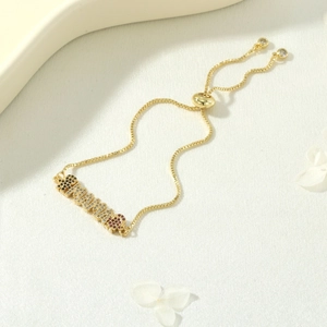 Macro shot of 18K gold-plated MAMA bracelet with multi-color zircon pavé settings