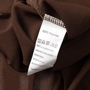 Detail of 100% polyester fabric texture and care label on brown knit crop top