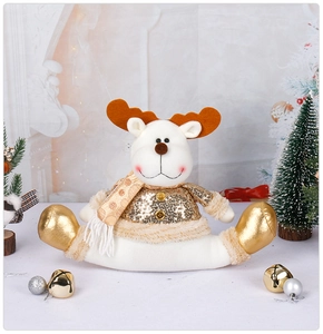 Close-up of reindeer plush toy with gold sequins and festive white fur Christmas decor
