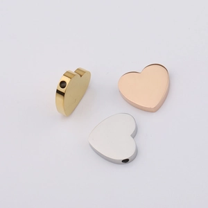 Detailed view of heart-shaped stainless steel beads in gold, silver, and rose gold colors
