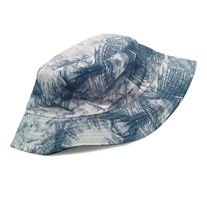 Detailed view of reinforced stitching and tropical palm leaf print on the bucket hat brim